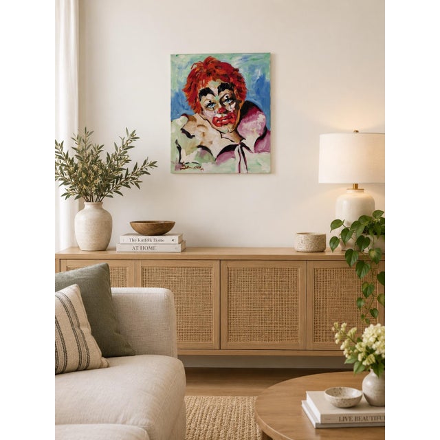 Striking vintage expressionist portrait depicting a theatrical clown with vivid red hair, piercing blue eyes, and...