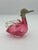 A sculptural mid‑century Czech art glass duck‑form decanter featuring a vibrant pink blown‑glass body with clear applied...