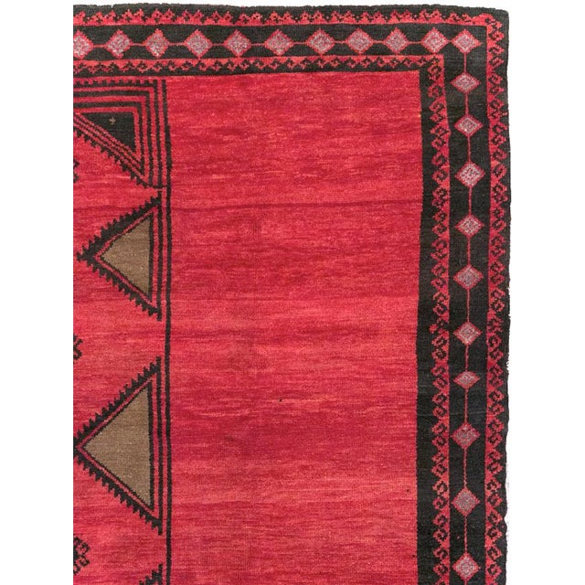 This Mid-20th century Turkish Anatolian tribal room-size carpet presents a bold composition dominated by a richly...