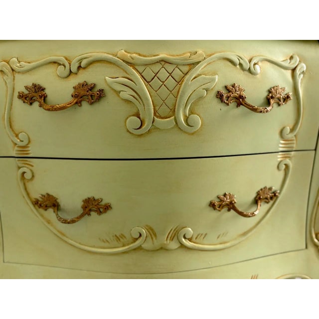 This elegant French Louis XV–style bombe chest exudes timeless sophistication with its curvaceous silhouette and refined...