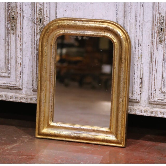 This refined antique French Louis Philippe wall mirror, crafted circa 1870, features the understated elegance and softly...