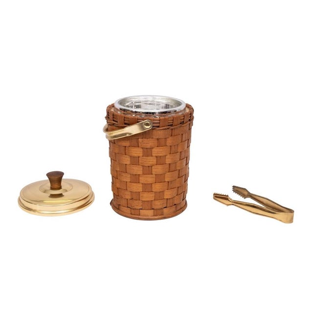 Very nice Ice Bucket Rapt with Wicker .comes with Brass lid and ice tongs . 1960s