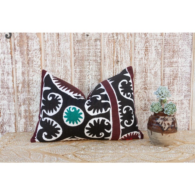 Made from a vintage Suzani tapestry, it features hand done embroidery and a solid linen back. Suzani is a Persian word...