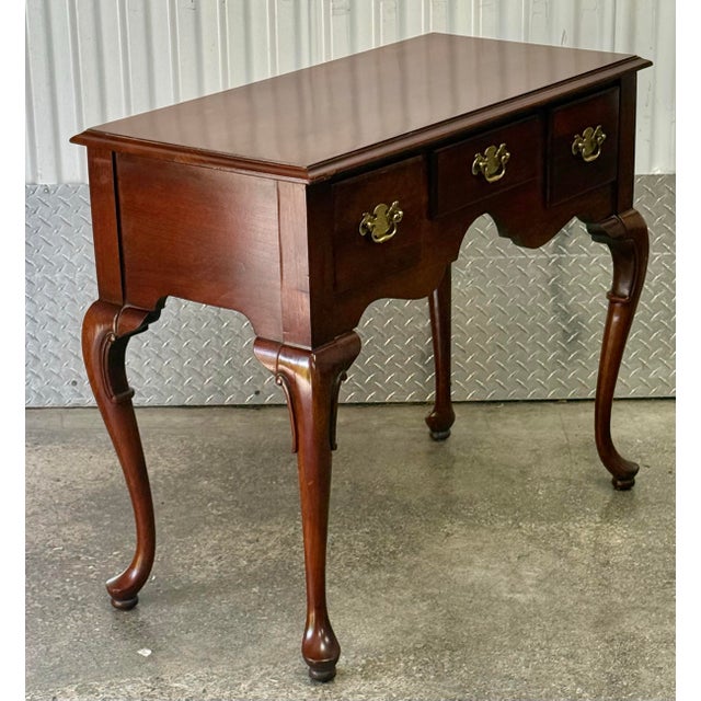 Elegant lowboy crafted in solid cherry. This piece showcases hallmark features of the early 18th-century style, including...