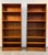 This pair of mid-century modern Danish teak tall bookcases features a warm golden-brown wood grain and multiple adjustable...