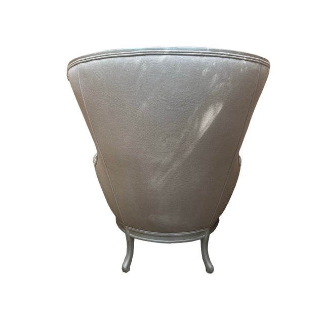 Cream colored wingback chair with silver coloring on the legs and arms with gorgeous floral carvings. I've had this chair...