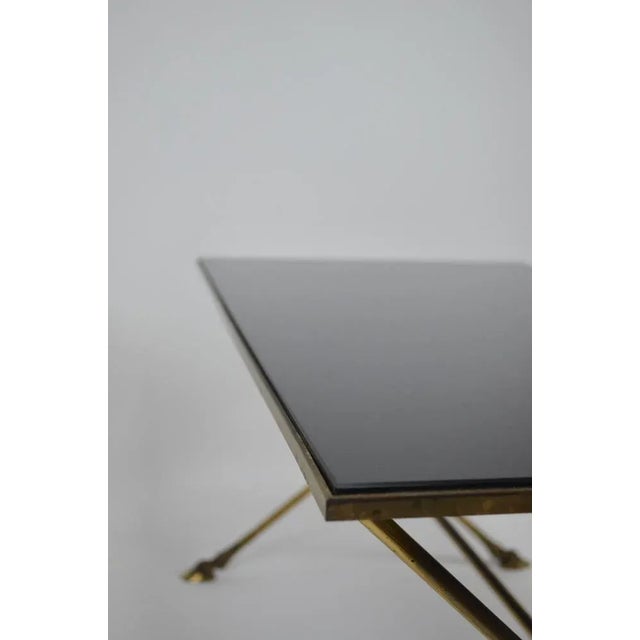 Elegant neo-classical table from the 60's in gilded brass by Maison JANSEN with hoof-shaped legs and bevelled top in black...