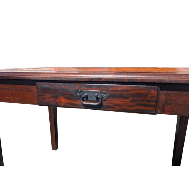 A handsome vintage writing desk handcrafted in Paraguay, featuring a warm cognac leather inset top with an elaborate hand-...