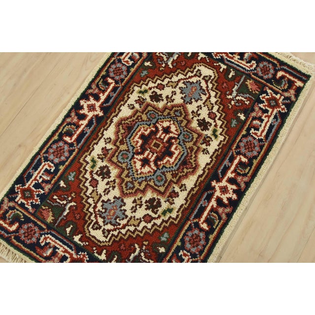 A traditional tribal Heriz rug hand-knotted with fine wool on a cotton foundation. This oriental rug features a central...