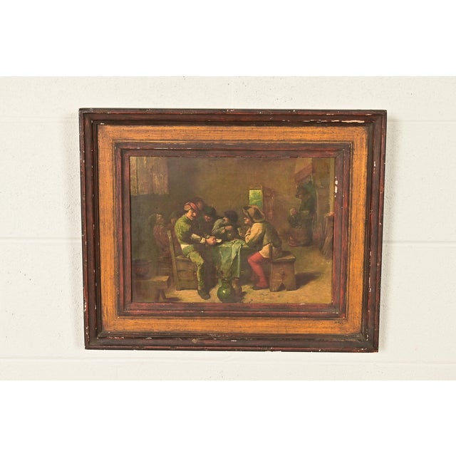 A beautiful reproduction oil painting on canvas of peasants playing cards in carved wood frame Original painting is by...