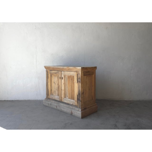 This perfectly distressed wooden cabinet has been weathered through the years. Aged from time and the elements, it has the...