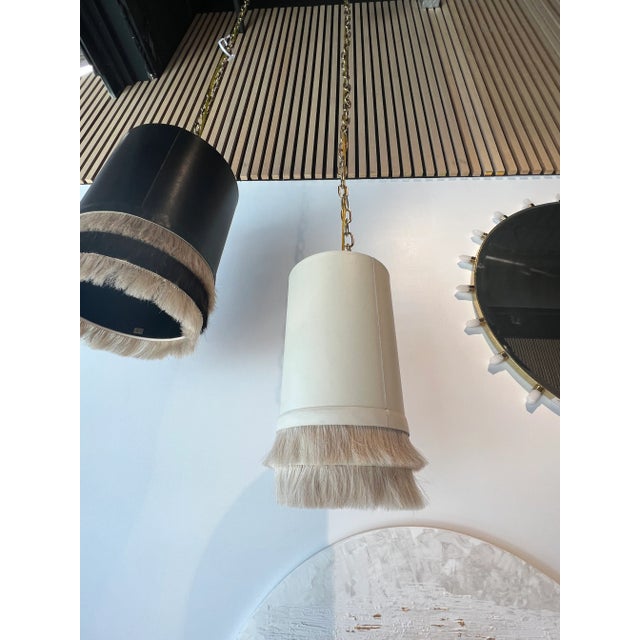 Dimensions: 8" Dia x 16" H Fixture 72" adjustable chain/cord 5" dia x 5" h canopy Gold cord, off-white shade with hair fringe