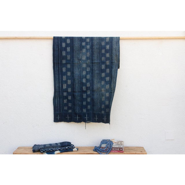 A masterwork of Malian textile heritage featuring deep indigo saturation and symbolic geometric motifs. Originating from...