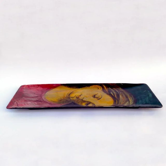 This painted dish depict's a woman's face.