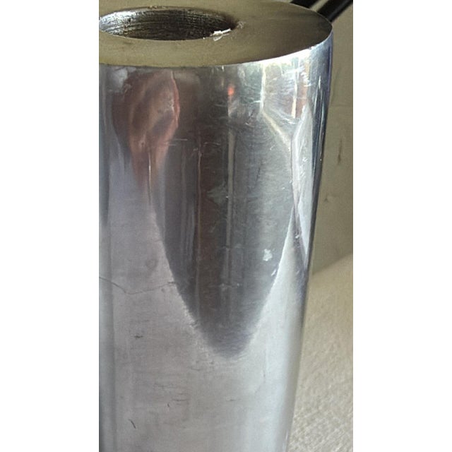 Pair of vintage modernist taper candle holders crafted from cast aluminum with a sleek silver-tone finish. These...