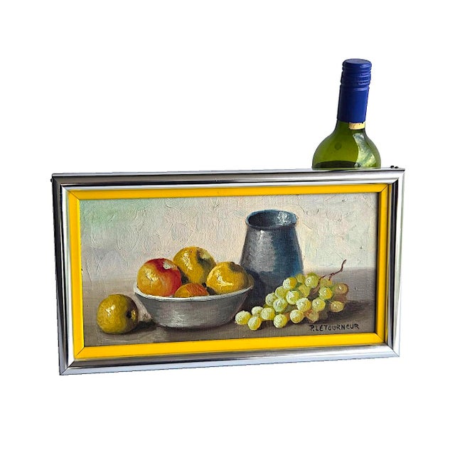 Offered is a small mid-century still life oil painting of an arrangement featuring yellow apples in a ceramic or metal...