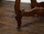 An Italian Baroque style walnut console table from the 18th century, with marquetry geometric top and carved base. Created...