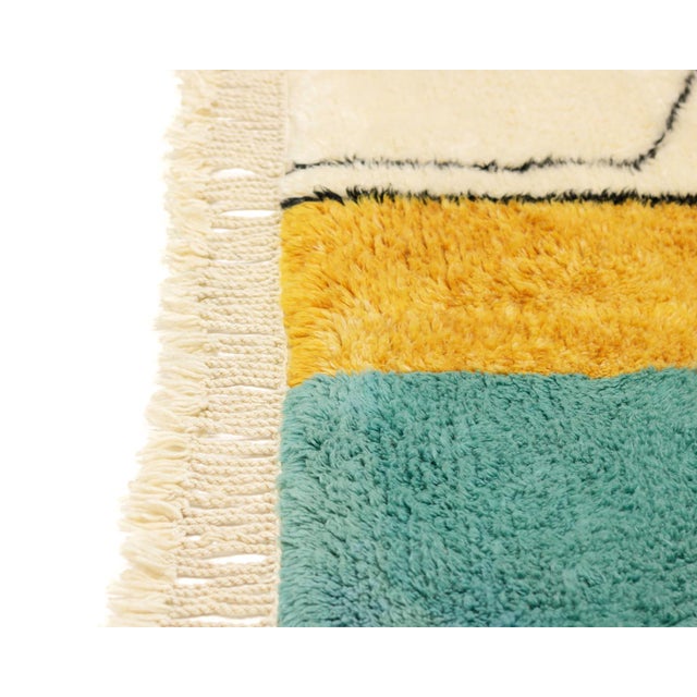An artist's collage, translated into wool — angular, layered, and full of quiet surprise. This hand-knotted wool rug...