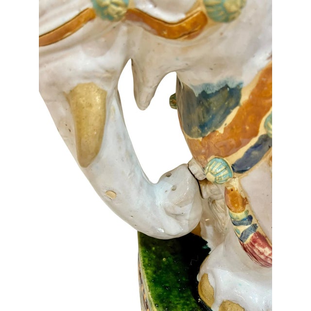 A striking vintage terracotta elephant garden seat featuring richly detailed, hand-painted decoration in a classic...