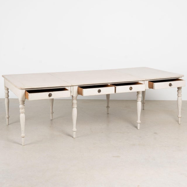 19th century large Swedish partners desk, crafted in pine with a newer antique white painted finish and pale gray...