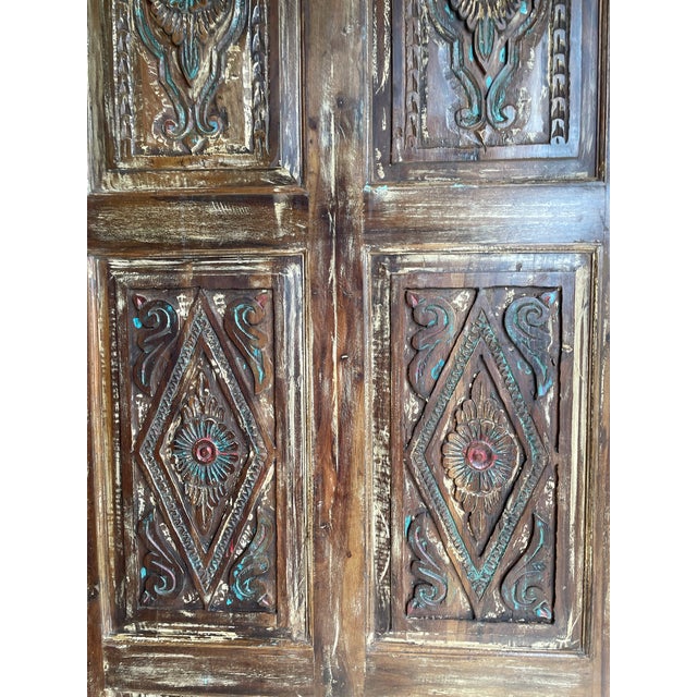 Bring timeless character to your home with this vintage floral carved barn door, handcrafted from reclaimed wood and rich...