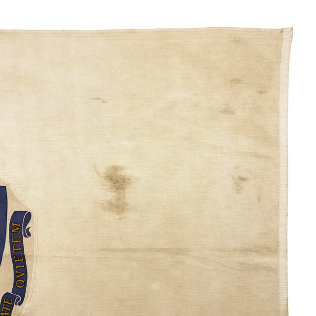 This vintage Massachusetts flag is made from a cotton cloth. Printed emblem is sewn around its edge, slightly askew, and...