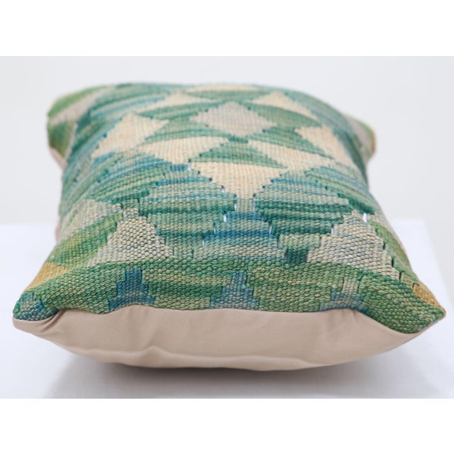 A one-of-a-kind handwoven Afghan wool kilim lumbar pillow featuring diamond lattice. Cut and sewn by hand from a flat-...