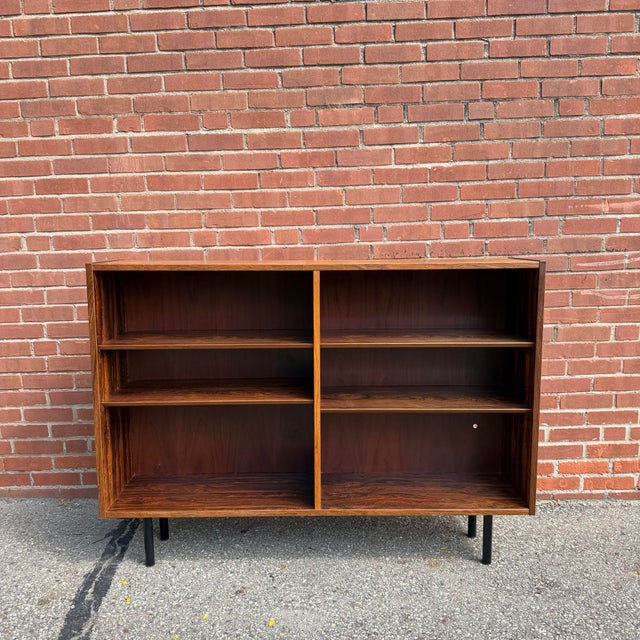 A beautifully grained Danish Modern rosewood bookcase dating to the 1960s. The dramatic rosewood veneer showcases striking...