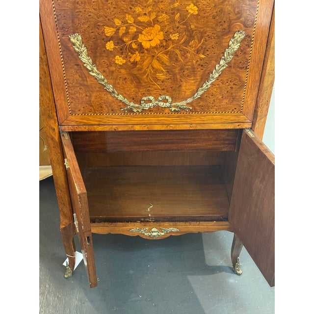 This is a 19th century marquetry secretary desk. It is Louis XVI style. It has a stunning neoclassical look. It has a...
