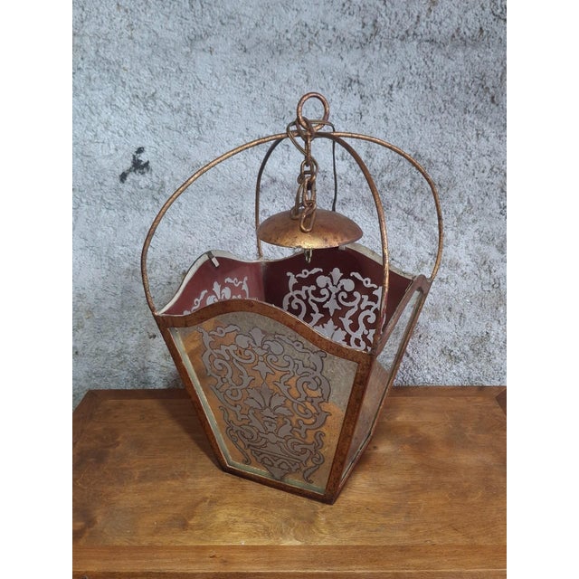 A sumptuous hanging lantern in the classical baroque style, likely of italian or mediterranean origin, dating from the...