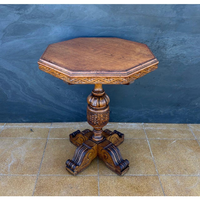 Elegant octagonal pedestal table crafted in solid oak wood, richly carved throughout in the Renaissance Revival tradition....