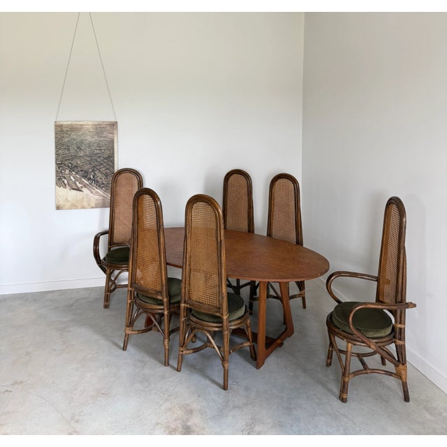 Unusually proportioned rattan and hand-caned dining chairs in an extra large, full set of eight. The set consists of six...