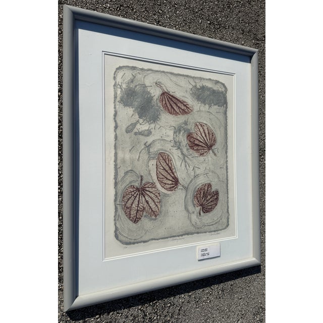 Framed piece of fine art printmaking titled "Floating Leaves" by the artist Laura Ames 1984. Artwork Details: • Title:...