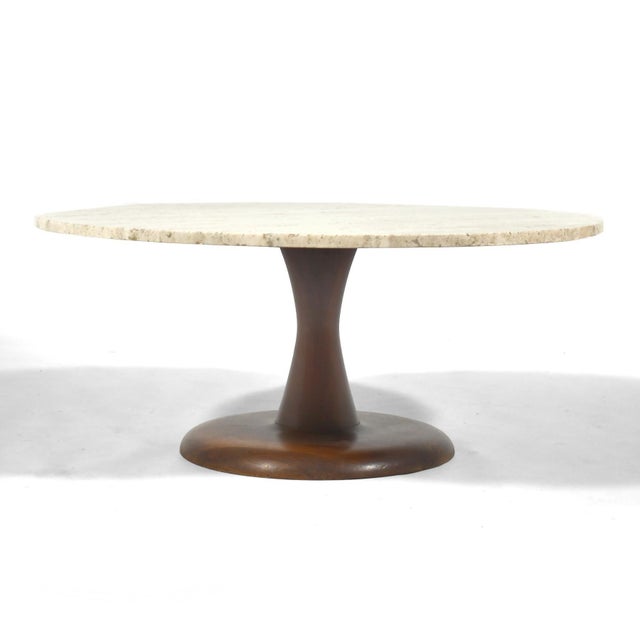 This pretty coffee table has a base of solid walnut turned in a pleasing shape reminiscent of Nanna Ditzel's "Toad Stool"...