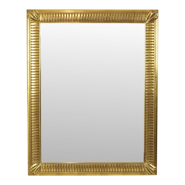 A beautiful, large gold-tone Deknudt mirror featuring a beveled edge and a design fully in the Hollywood Regency style;...