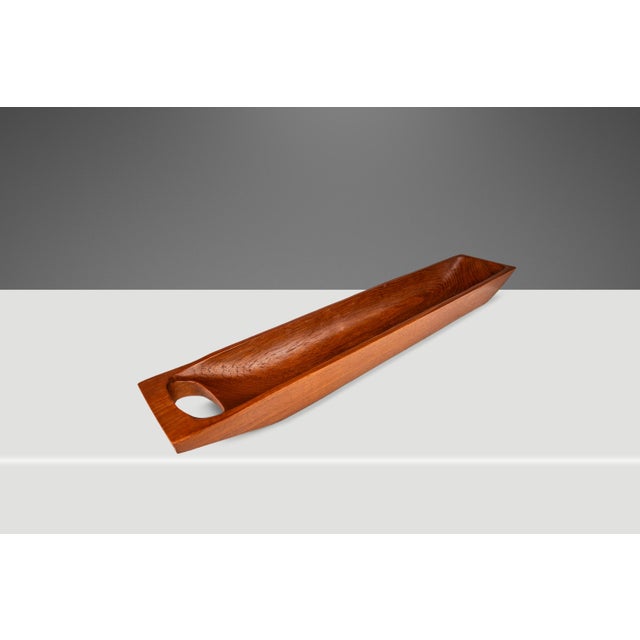 Introducing a quintessentially Organic Modern catch-all tray hand-carved from a solid slab of Burmese teak. Replete with...