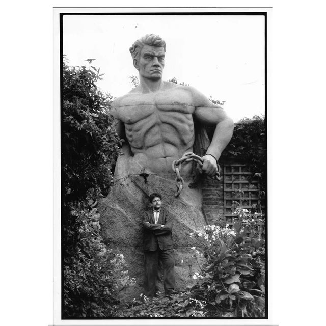 1989 photograph by British photographer Richard Watt of set designer David Fielding in his backyard with a giant male nude...