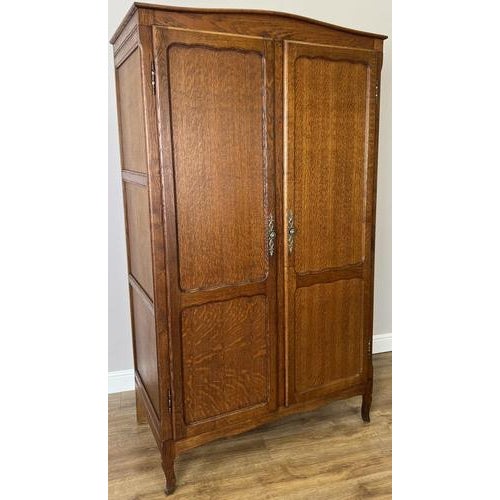 This elegant Vintage French Louis wardrobe features a rich oak finish, beautifully panelled doors, and graceful shaping...