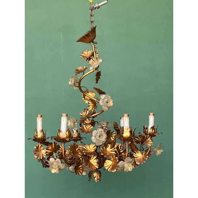 This stunning six light Italian gilded toleware chandelier features a foliage design with leaves and glass roses...