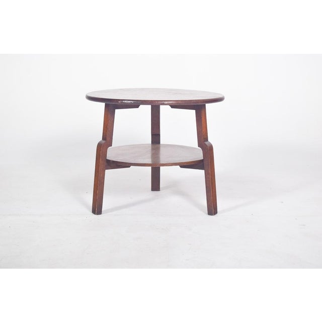 Round side table in oak. with two circular surfaces, an upper top with a gently curved edge and a lower shelf in a...