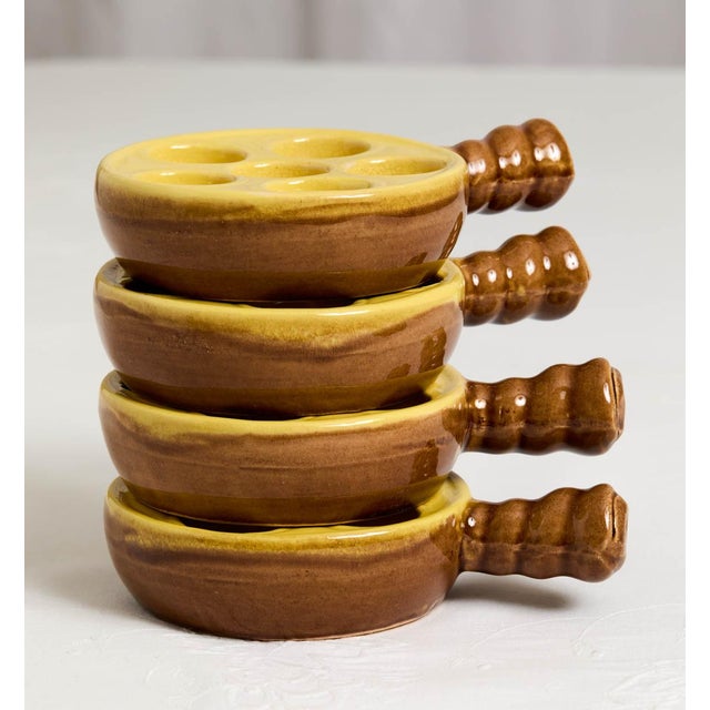 Wonderful set of 4 vintage French ceramic quail's egg or escargot holders. The yellow and brown-colored four-piece set is...
