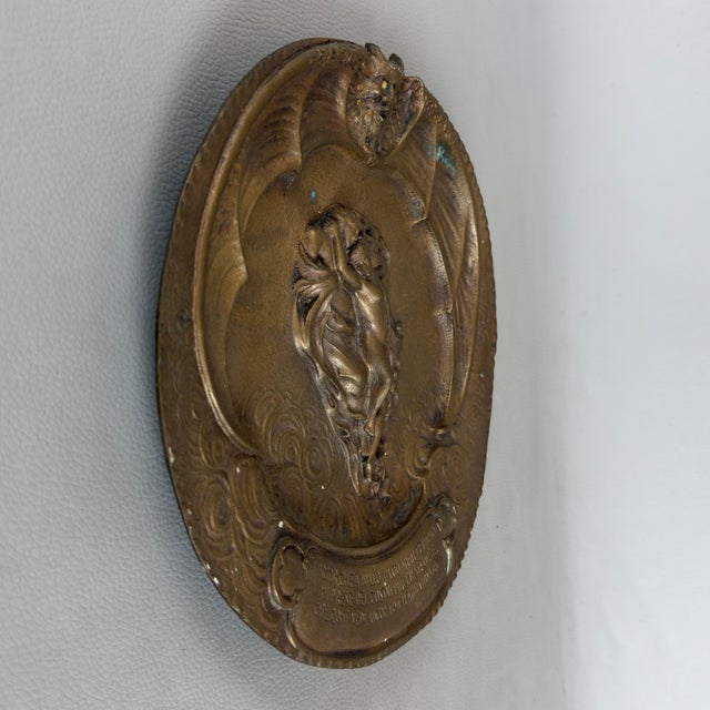 An evocative cast and chiseled bronze wall bas-relief inspired by Canto V of Dante's Inferno, featuring the figures of...