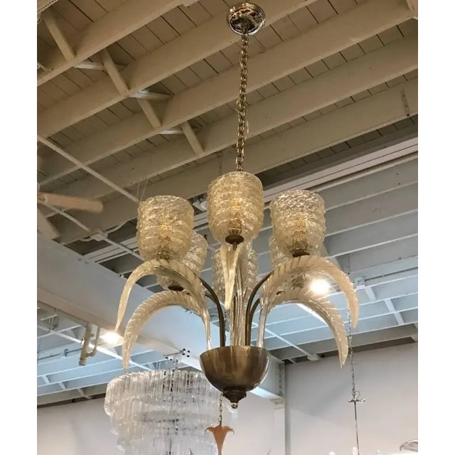 Stunning and elegant Italian Mid-Century Modern chandelier by Barovier e Toso. Having six Murano glass shades with six...