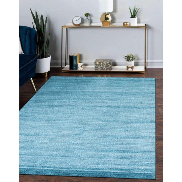 This blue hand knotted pile rug is crafted from a blend of wool and viscose to create a durable and functional floor...