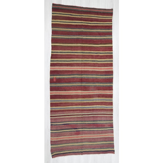 Vintage hand-woven striped kilim rug from the Konya region of Turkey. In good condition. Approximately 40-50 years old.