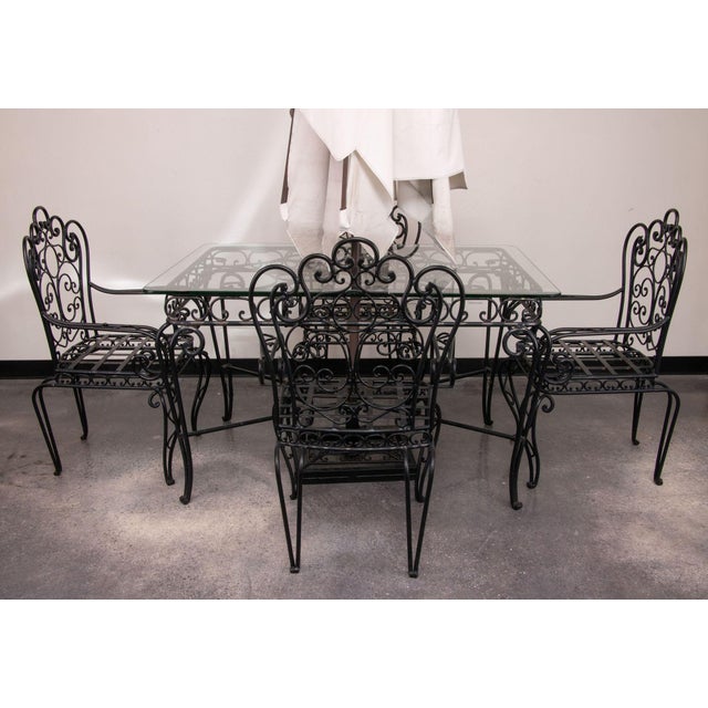 Black wrought iron patio set, intricately hand-forged with beautiful scroll detail. Including table, four chairs, and...