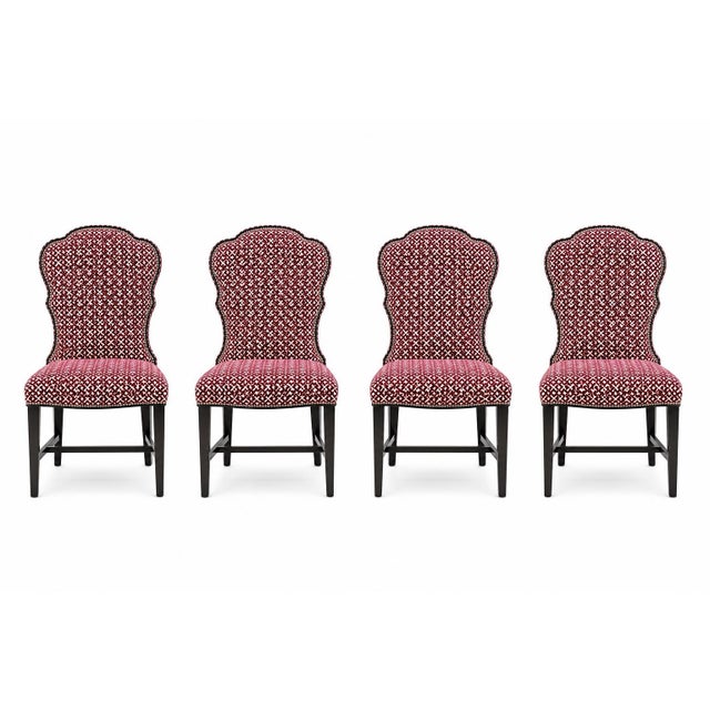 A stylish set of four dining chairs by Lillian August, featuring an elegant scalloped back and richly upholstered velvet...