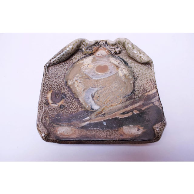 Stoneware slab / decorative plate with of an attractive palette of earth tones with pops of pink for contrast and a...