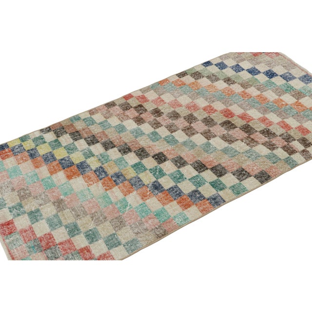 Hand-knotted in wool circa 1960-1970, this 3x5 vintage rug is believed to originate from the rare works of mid-century...