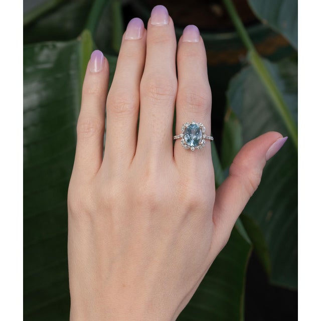 A luminous 3.2ct aquamarine in an elegant 11x9mm cut glows with serene, ocean-blue brilliance. Set in solid 14K dual gold...